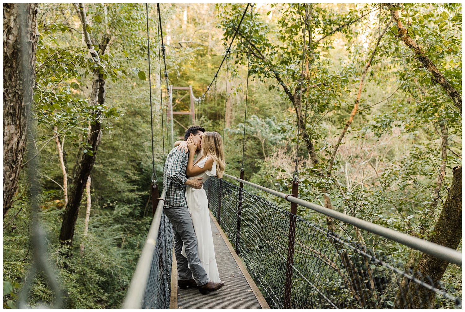 Cute, young couple on a suspension bridge during an engagement session in Lullwater Park in Atlanta, Georgia