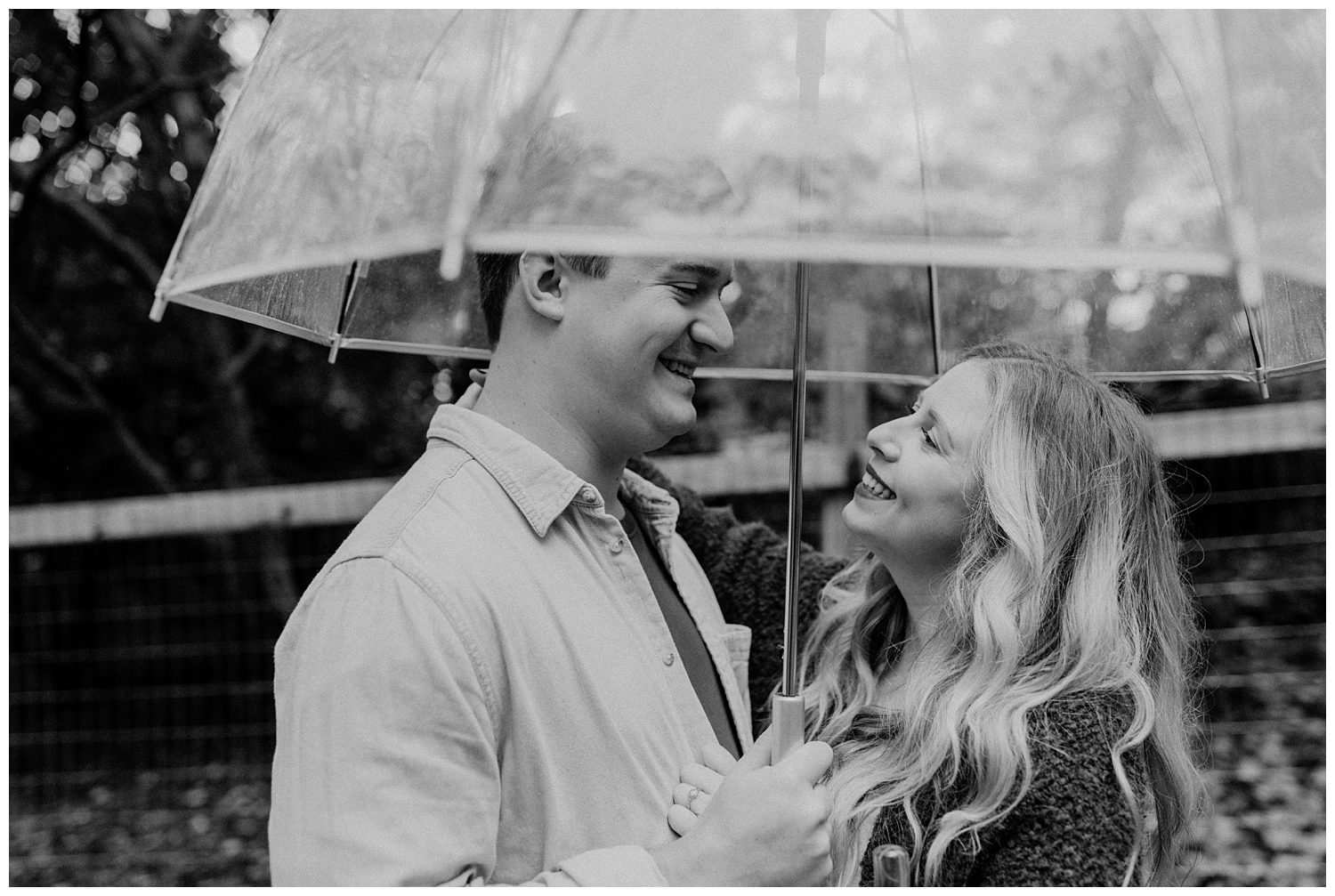 Rainy Day Engagement Session in Marietta, Georgia with cute couple under clear umbrella
