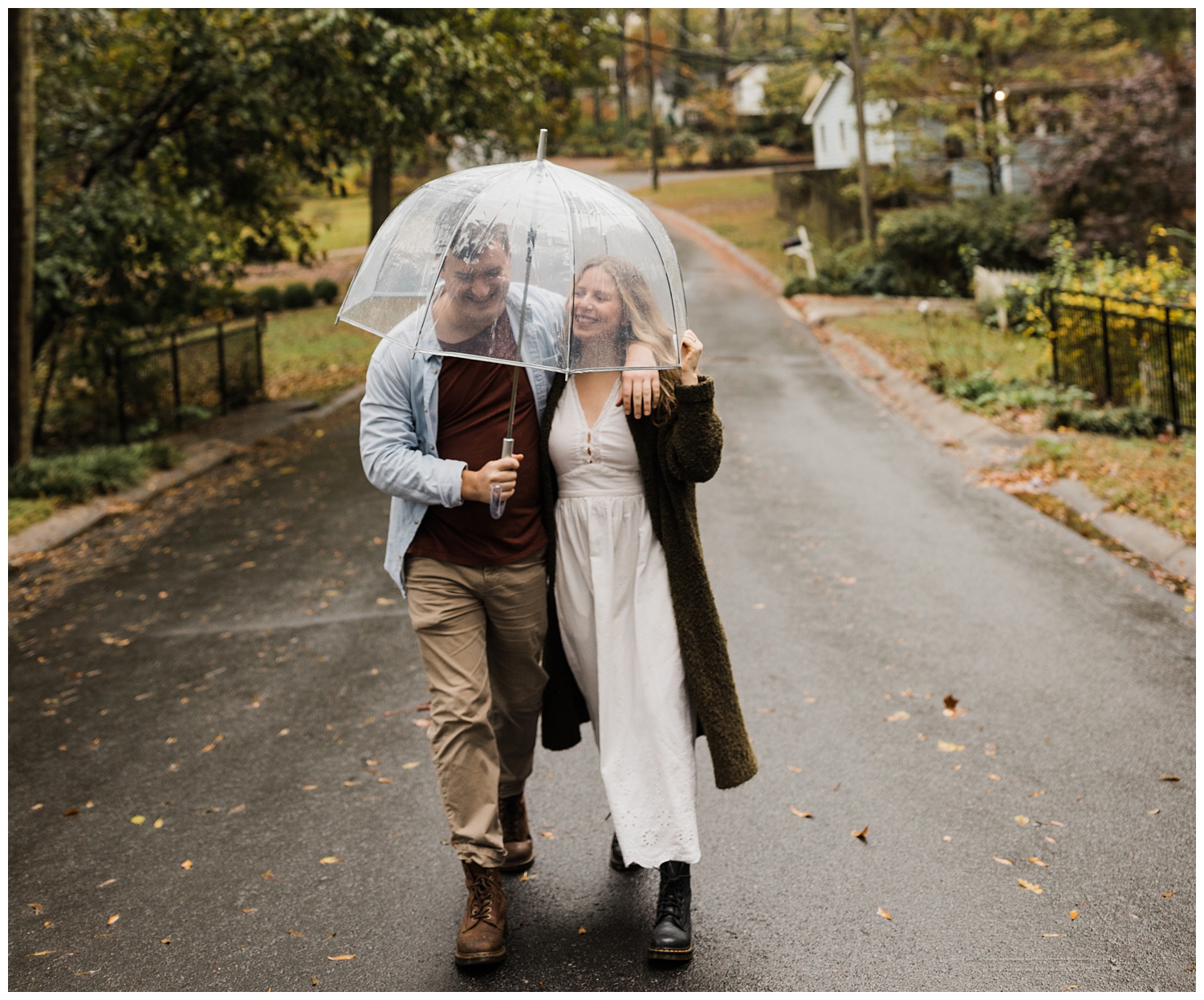 Rainy Day Engagement Session in Marietta, Georgia with cute couple laughing in the rain walking down the street