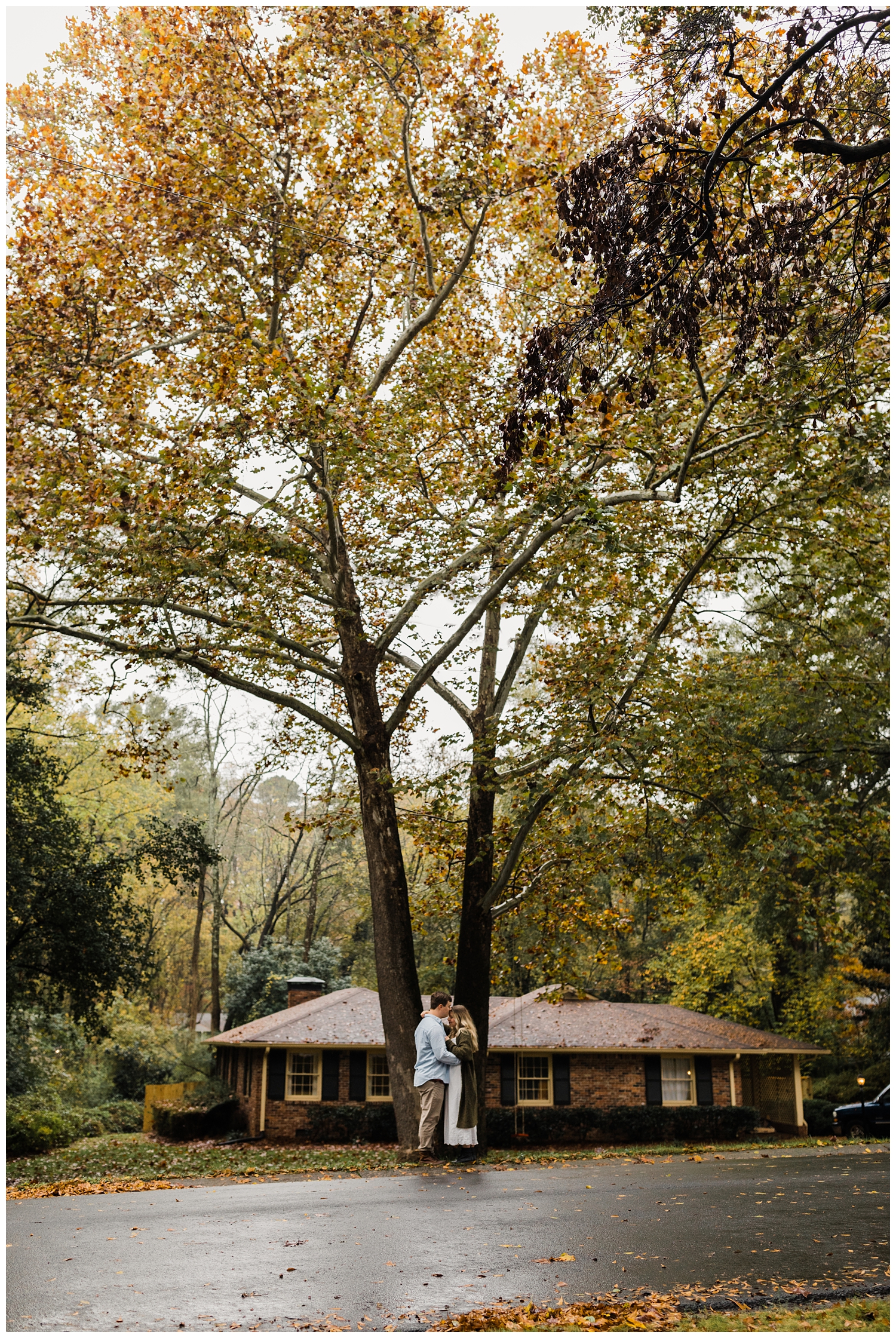Rainy Day Engagement Session in Marietta, Georgia with cute couple snuggling in their front yard