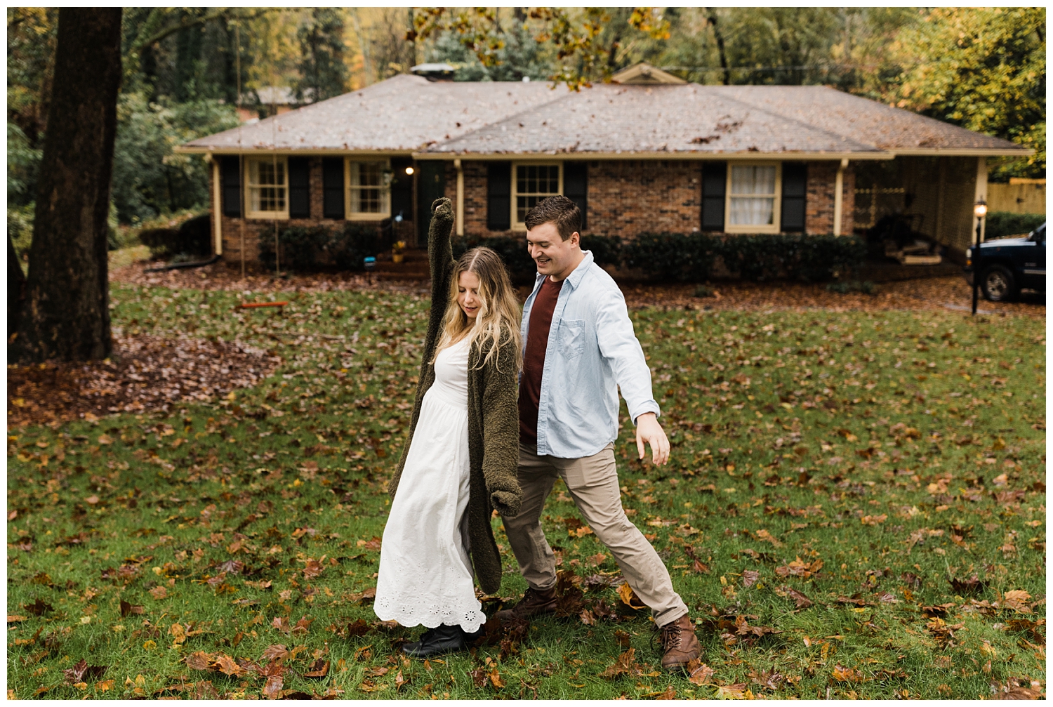 Rainy Day Engagement Session in Marietta, Georgia with cute couple dancing in their front yard