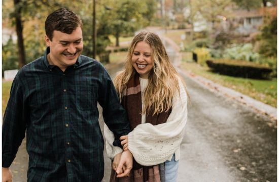 rainy day engagement session in marietta, georgia with cute couple running and laughing down a neighborhood street